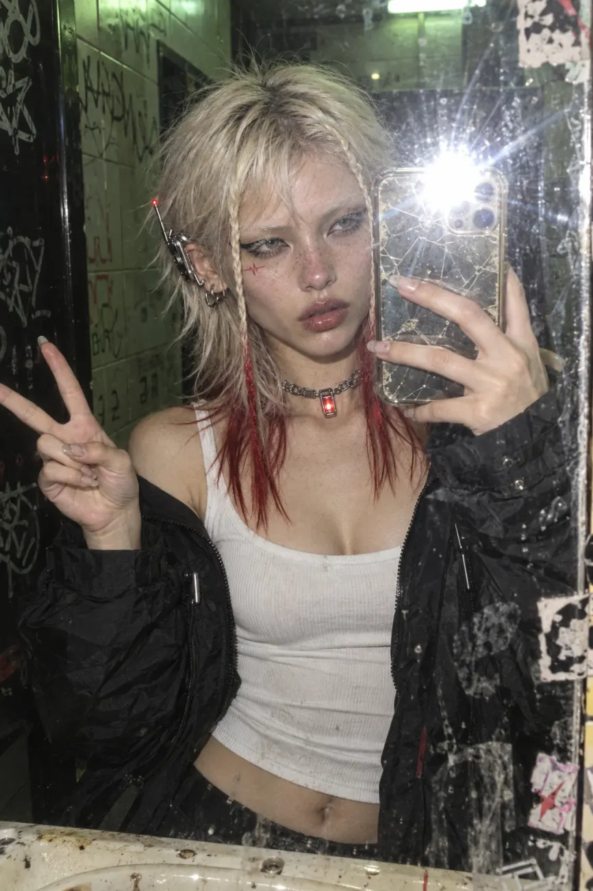 Flash mirror selfie in a club bathroom